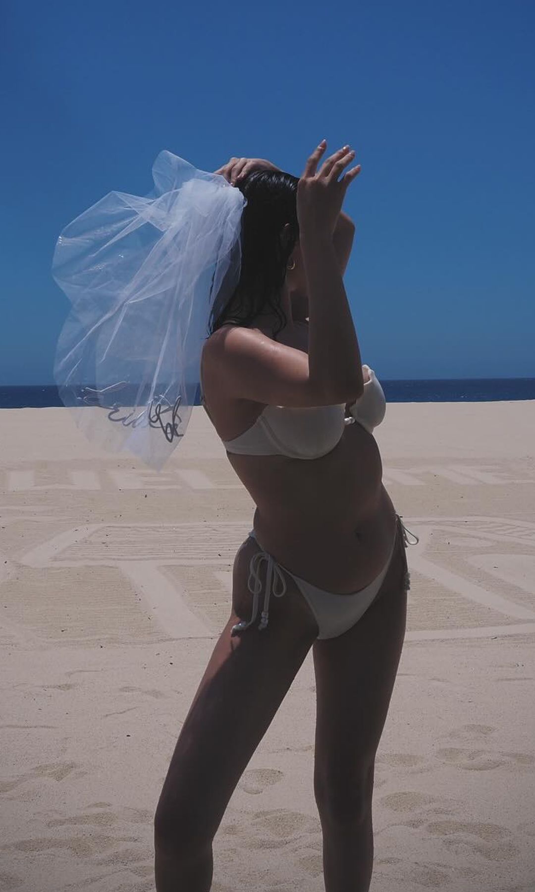 Selena Gomez poses in a bikini on a the beach