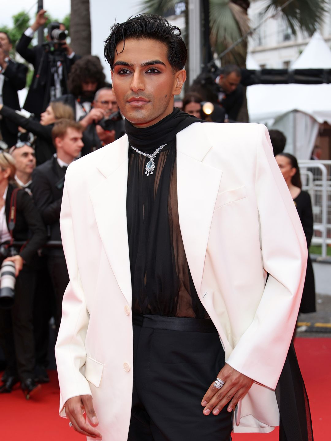 Rahi Chadda in a white suit jacket and sheer top