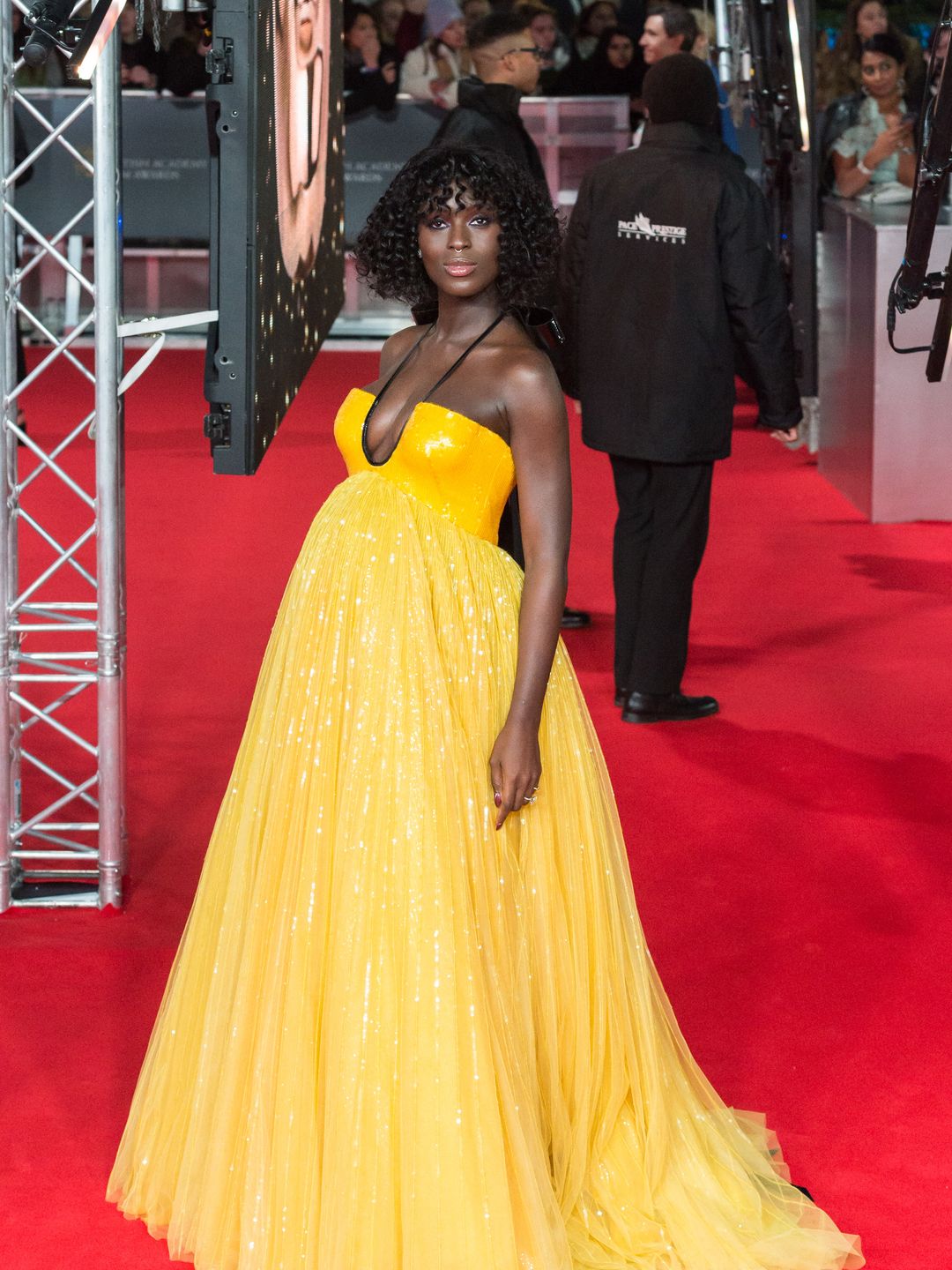 Jodie Turner-Smith attends the EE British Academy Film Awards in a bright yellow dress