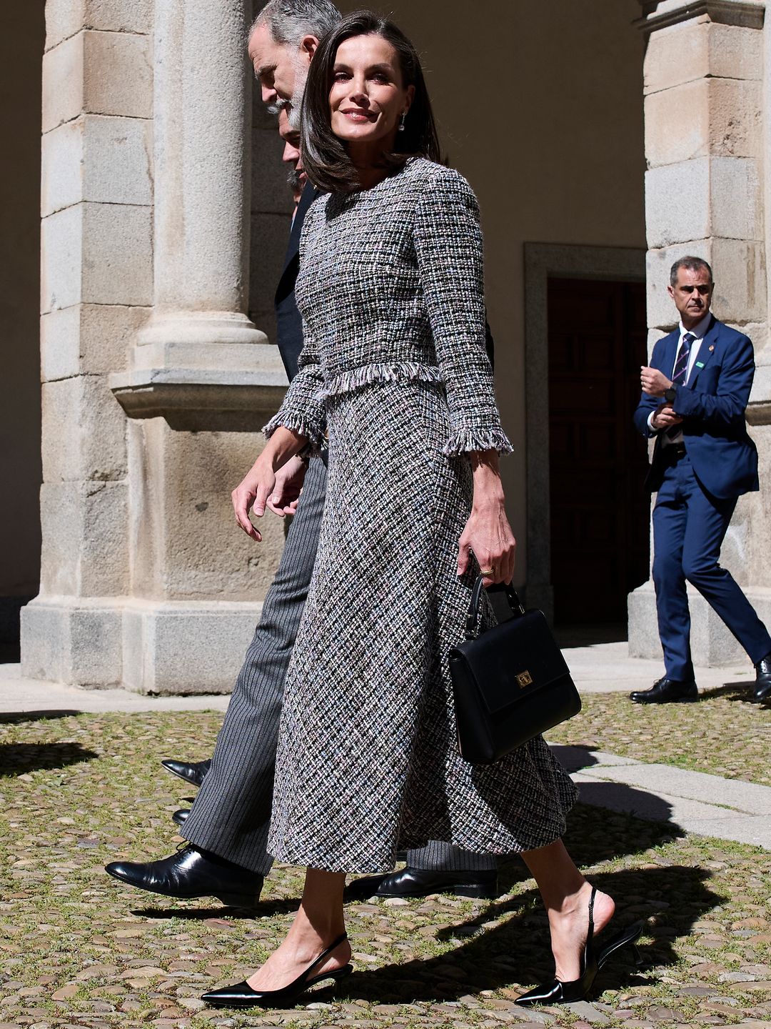 Queen Letizia of Spain wears a tweed dress while in Spain