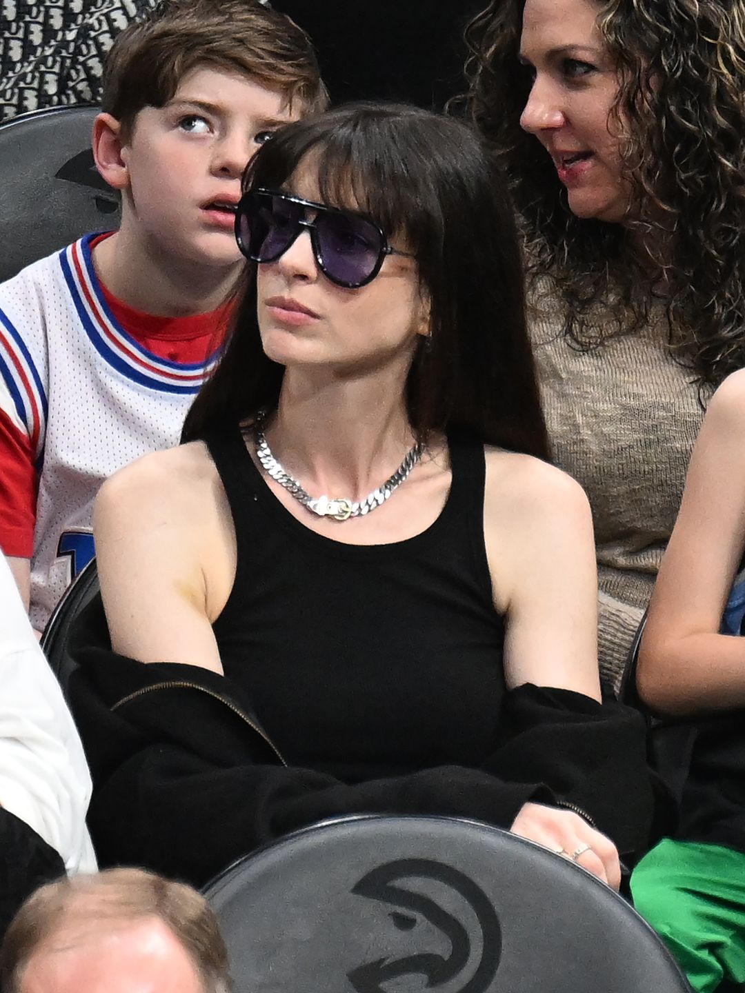 Actress Anne Hathaway attends the game between the Atlanta Hawks and the Charlotte Hornets at State Farm Arena on March 23, 2024