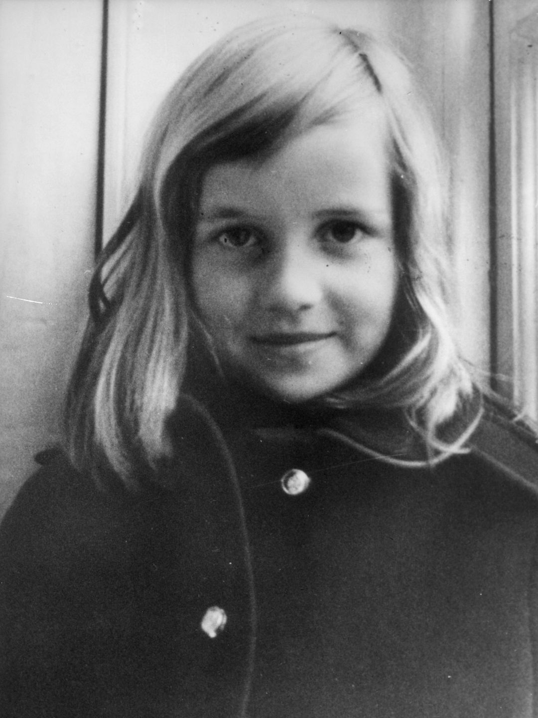 A young Princess Diana in a black coat