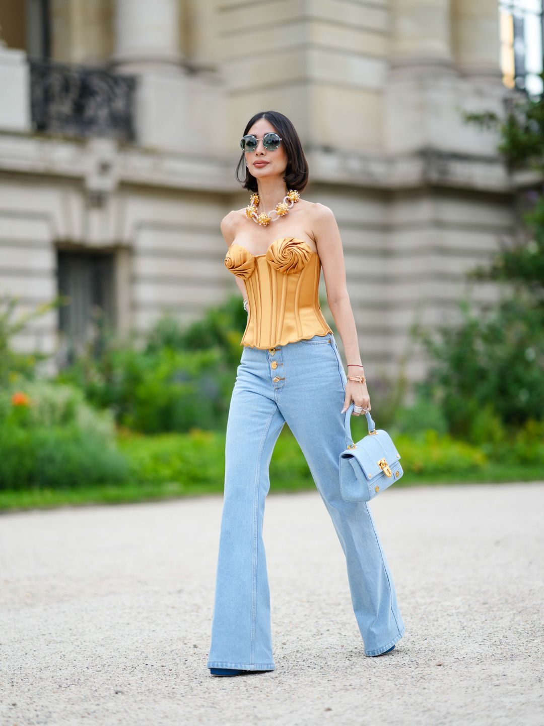 Heart Evangelista wearing pale blue flares with a gold corset 