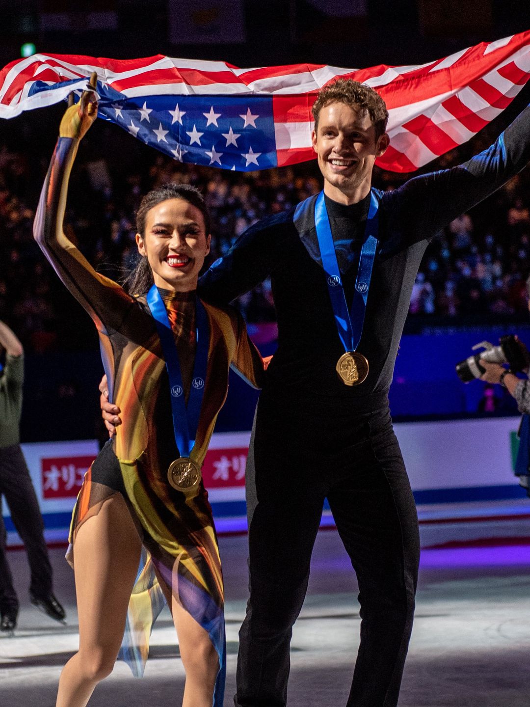 Madison Chock and Evan Bates holding up the American flag