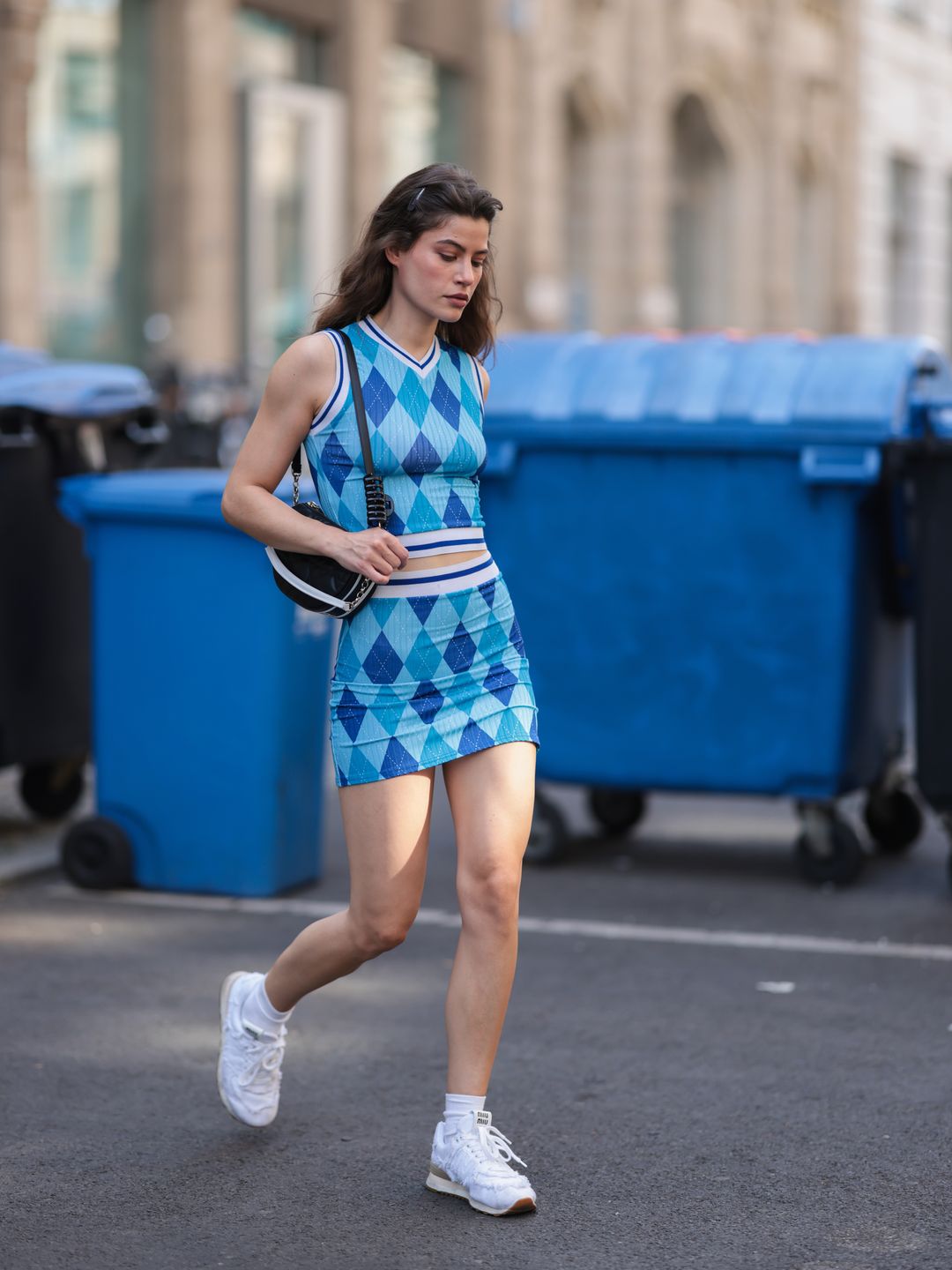  Lea Naumann wears a blue argyle print top and matching mini skirt 