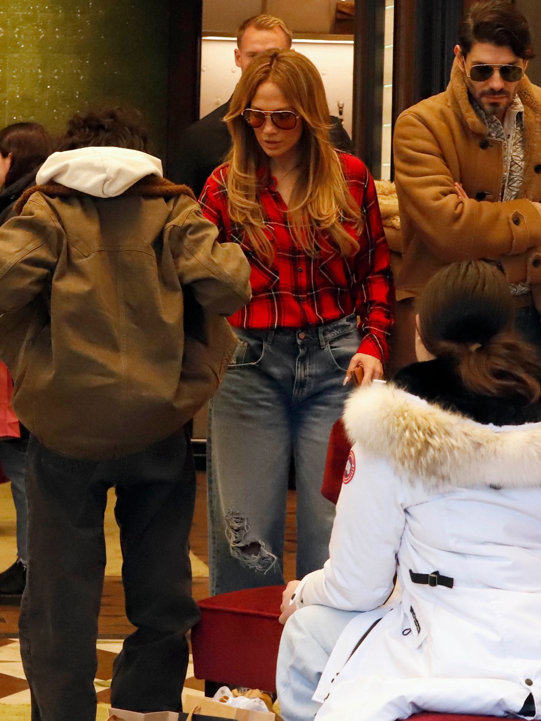 Jennifer Lopez in Aspen on Christmas Eve, wearing a red checked flannel shirt and jeans