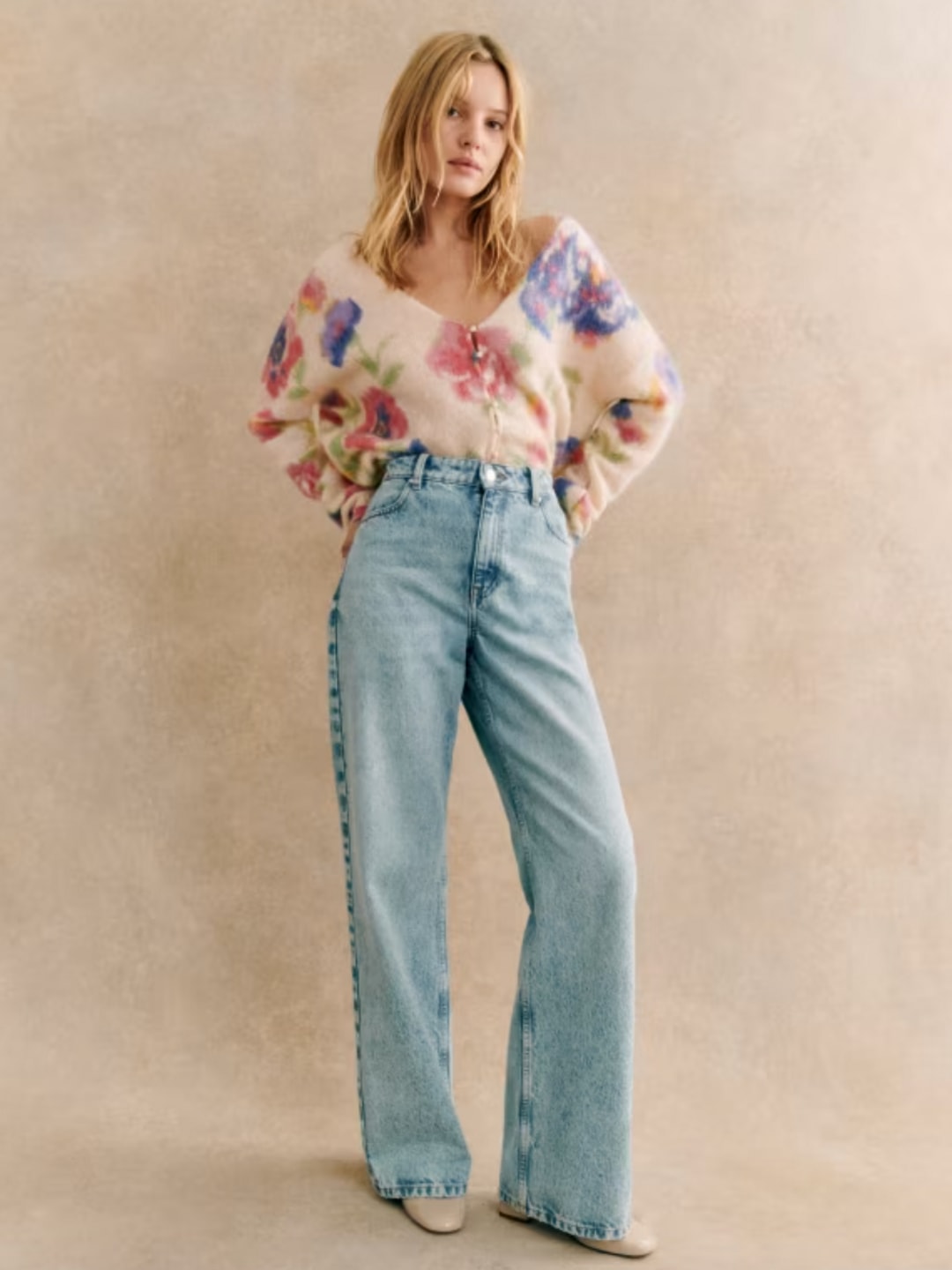 Sezane model wearing a floral cardigan and jeans 