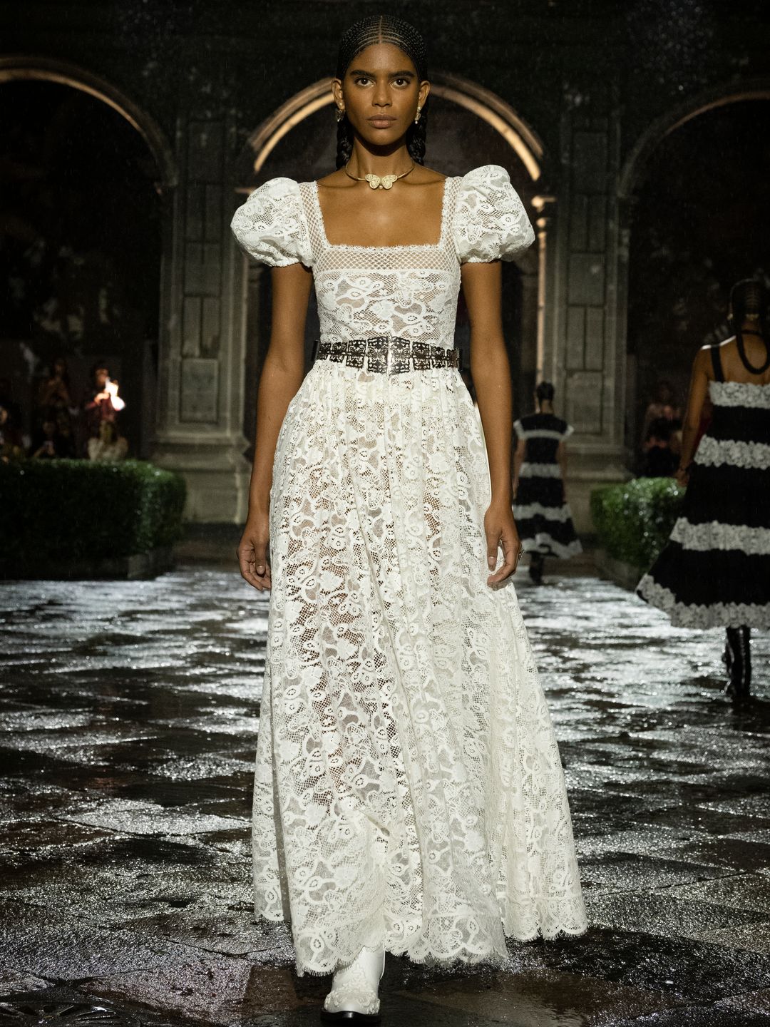 Dior model wearing a white lace short sleeve dress 
