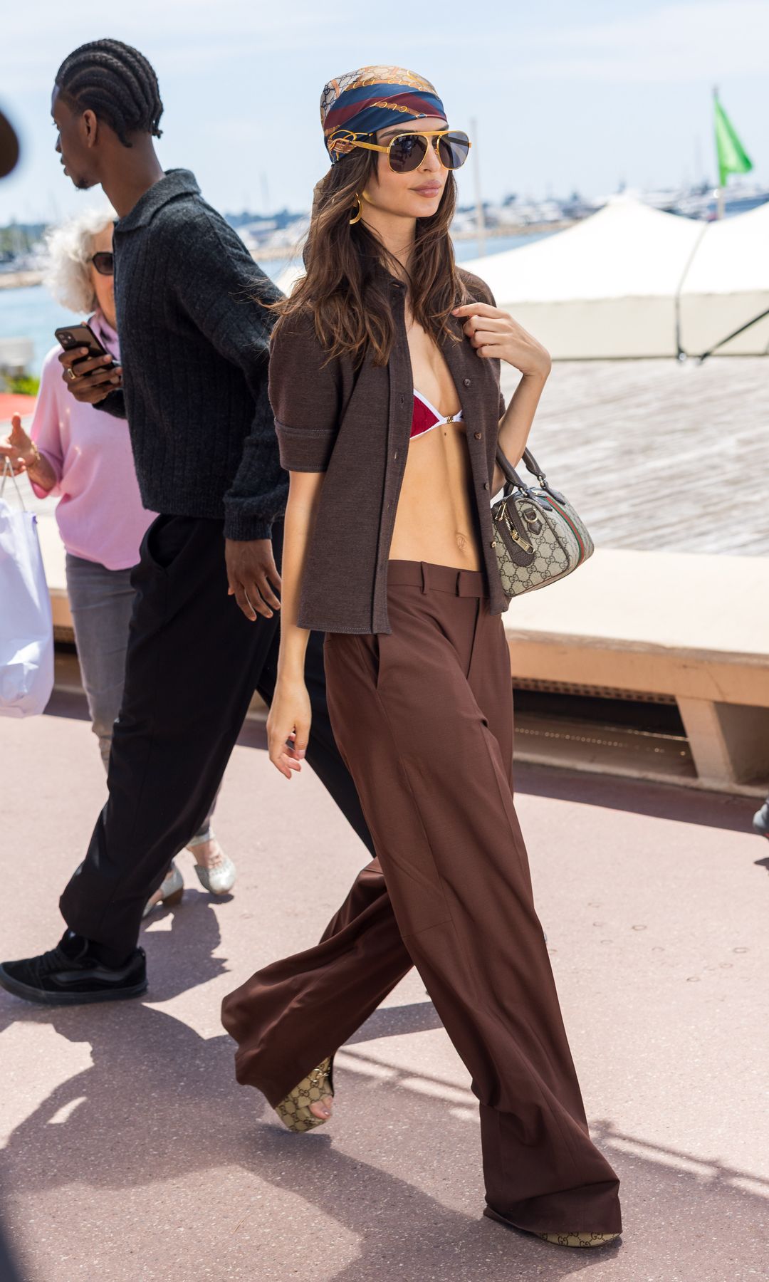 Emily Ratajkowski is seen on the croisette filming a commercial during day nine of the 78th Cannes Film Festival on May 21, 2025 in Cannes, France in a bikini and brown torusers