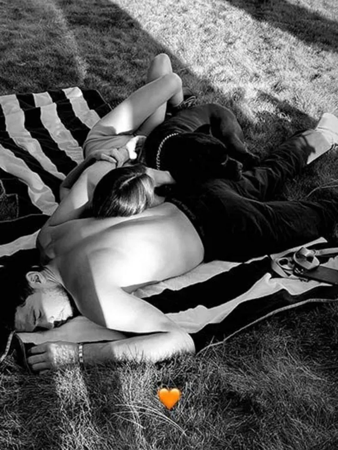 Black and white photo of Kendall and Devin relaxing together on some grass