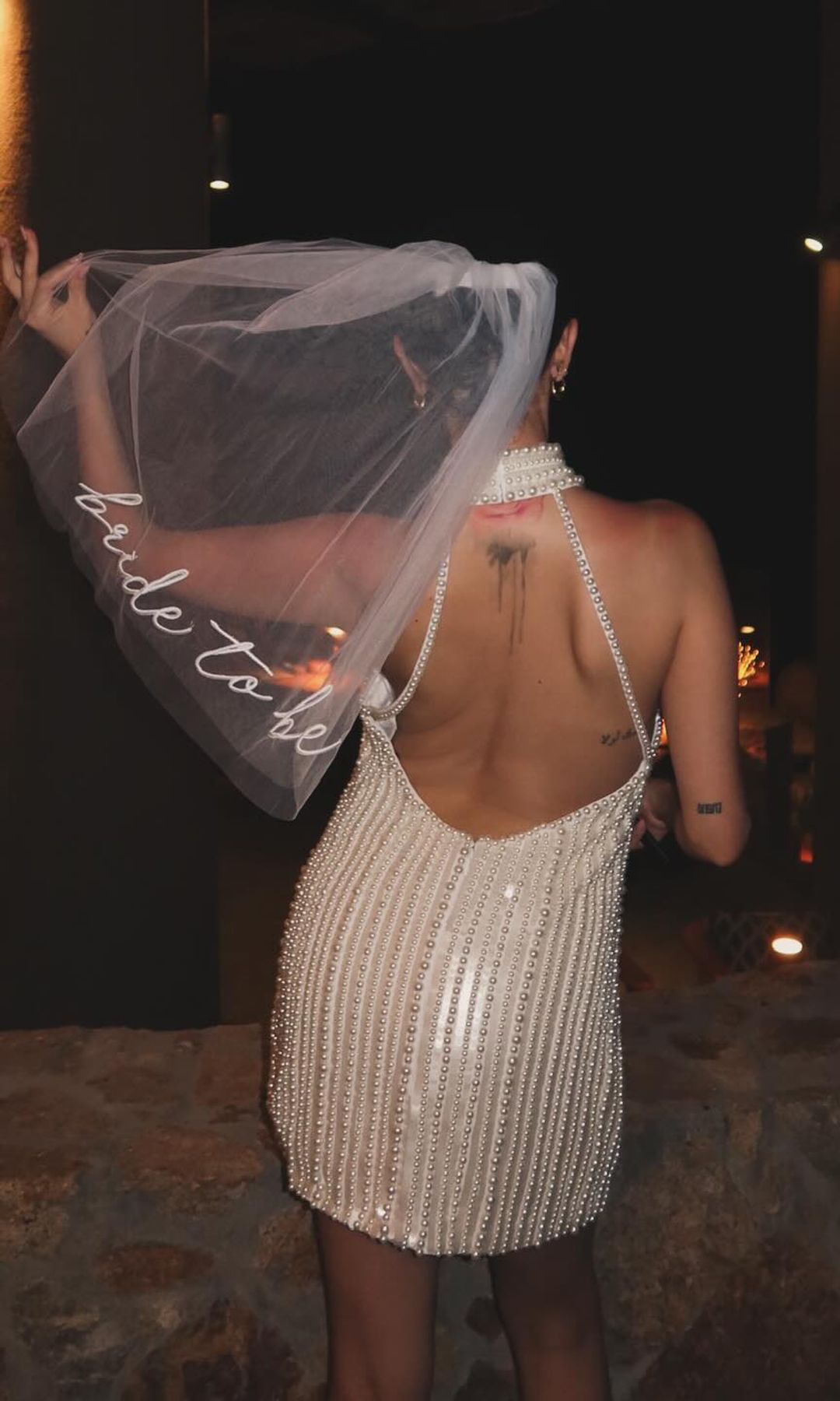 Selena Gomez poses at a resort in a beaded mini dress 