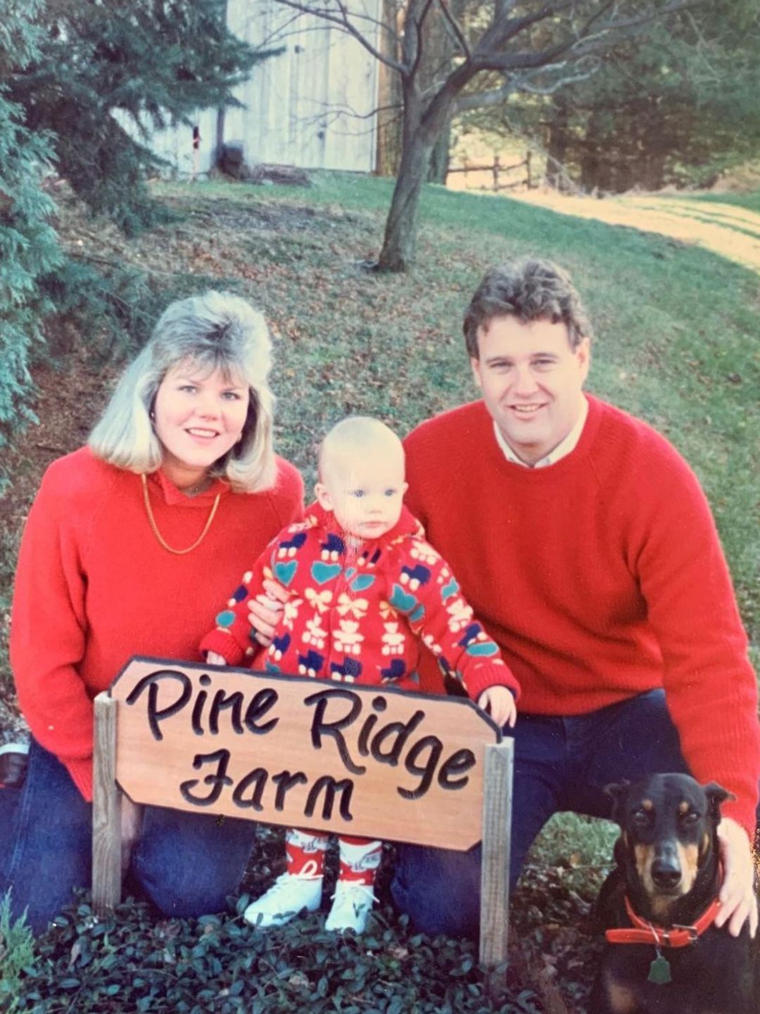 A baby Taylor with her parents on their Christmas tree farm