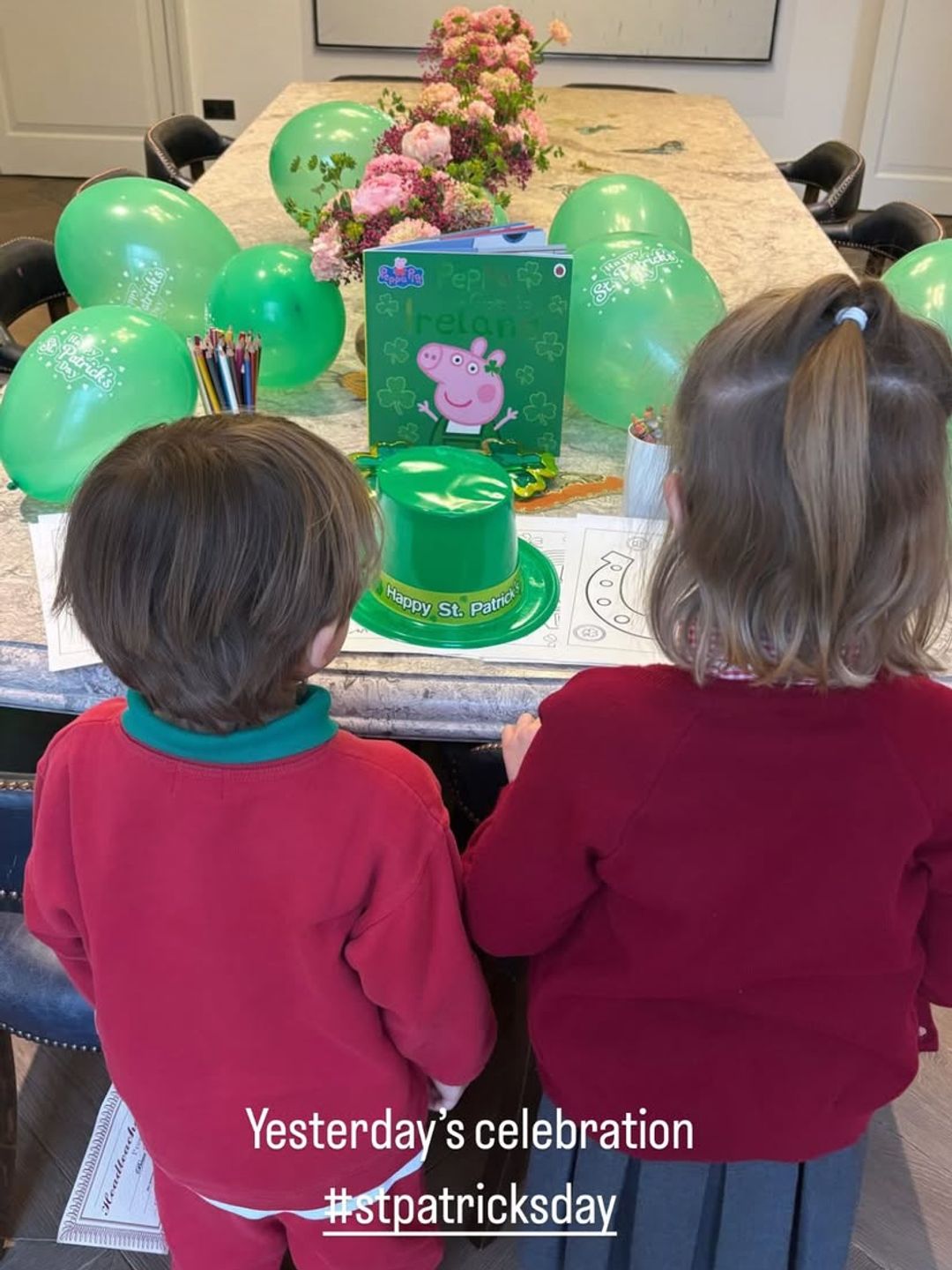 Ayda Field's daughter and son with their backs to the camera looking at St Patrick's Day decorations