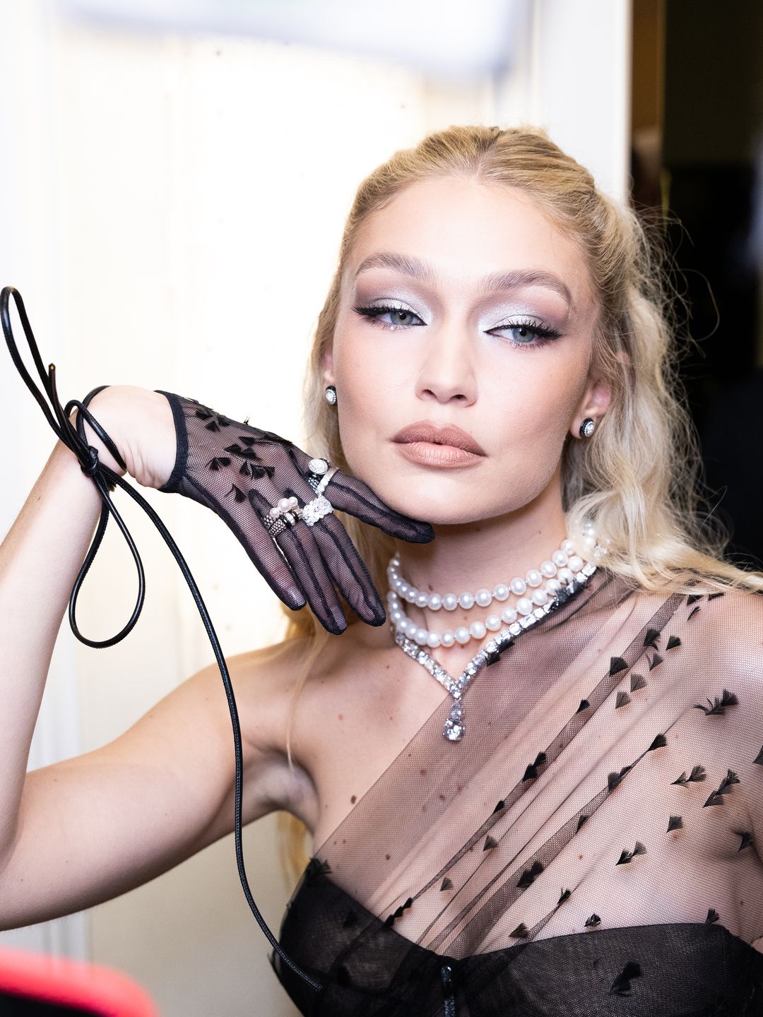 Gigi Hadid poses in lace gloves ahead of the 2023 Met Gala