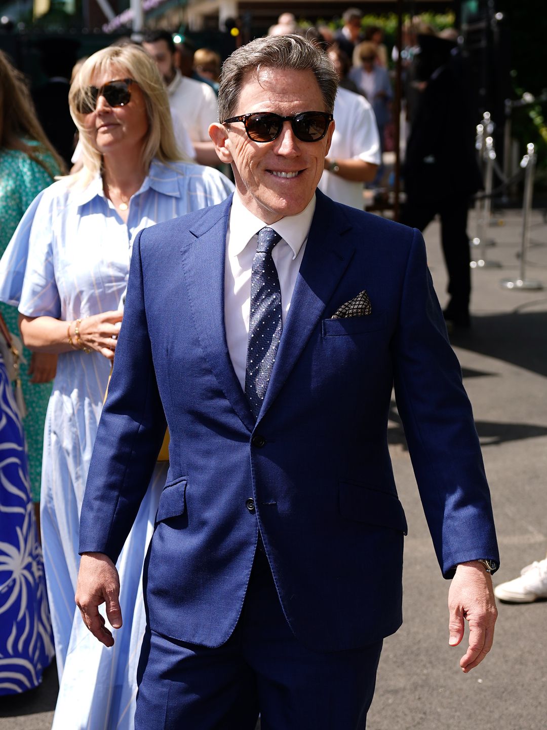 rob brydon at wimbledon in navy suit 