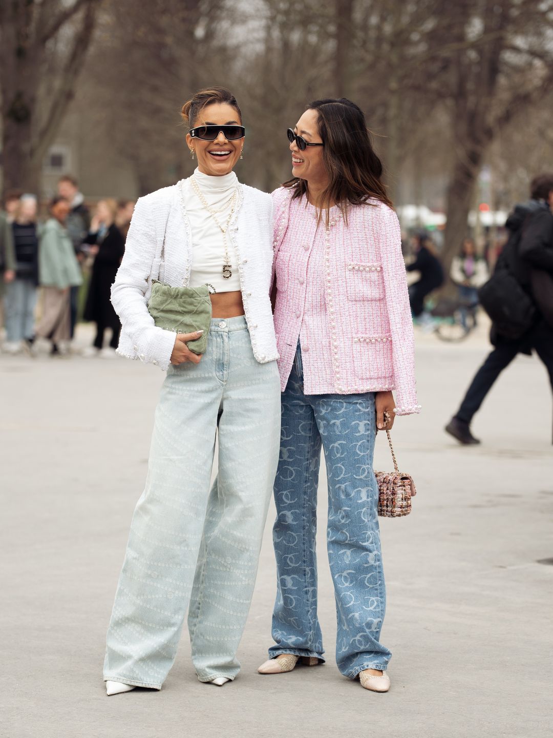 Camila Coelho and Aimee Song outside the Chanel AW25 show in Paris