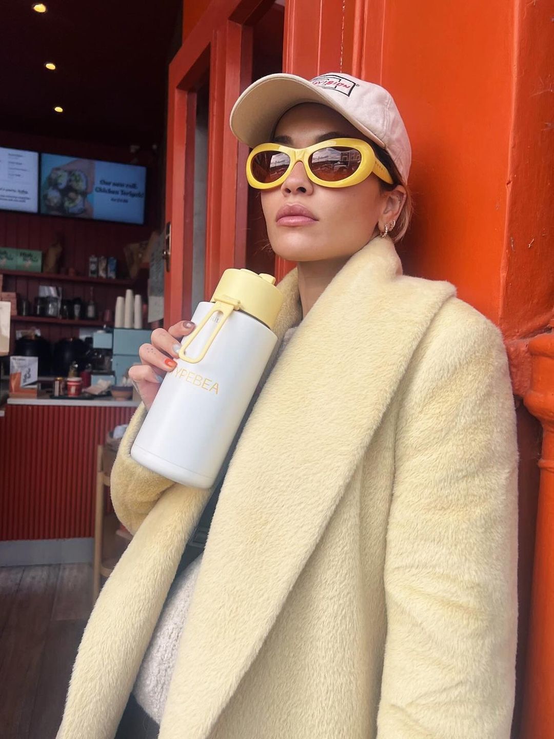 Rita Ora poses in yellow sunglasses