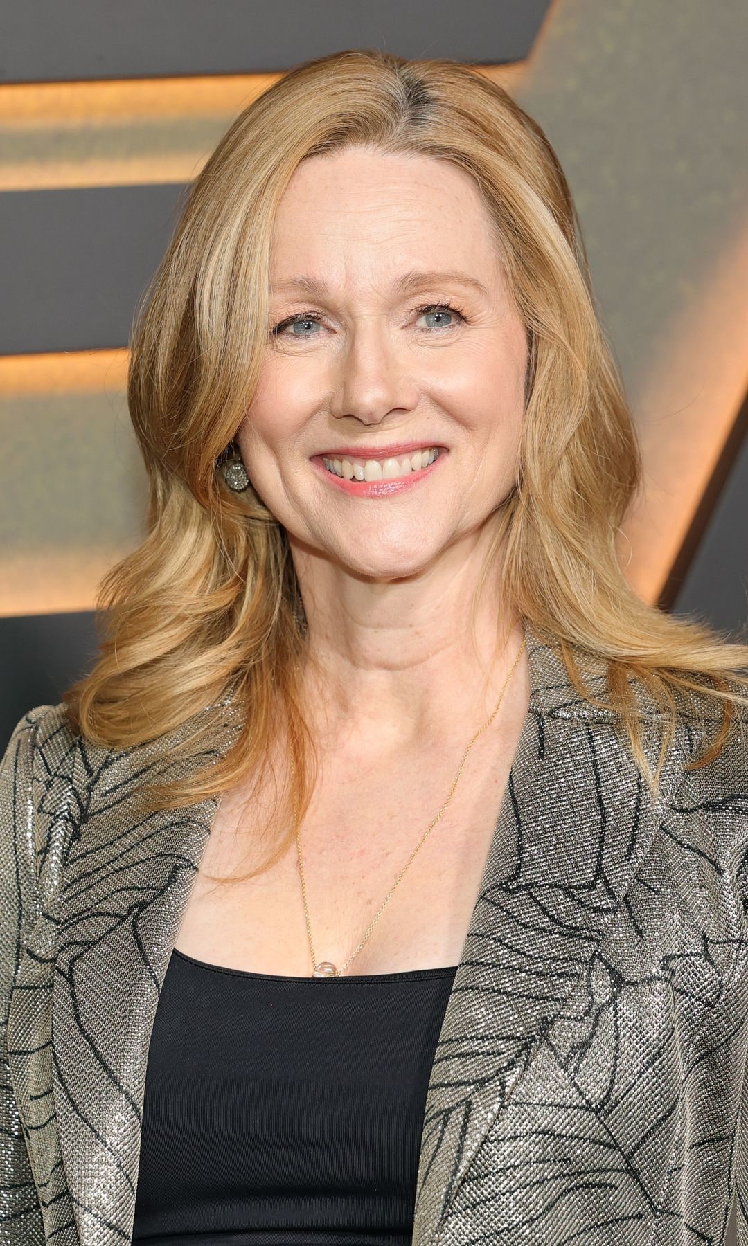 Laura Linney in a silver suit