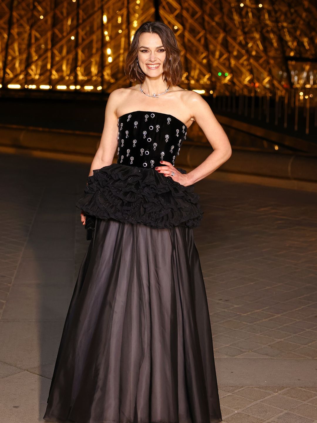 Keira Knightley attends the "Le Grand Diner du Louvre" Passage Richelieu Photocall at Musee du Louvre on March 04, 2025 in Paris, France