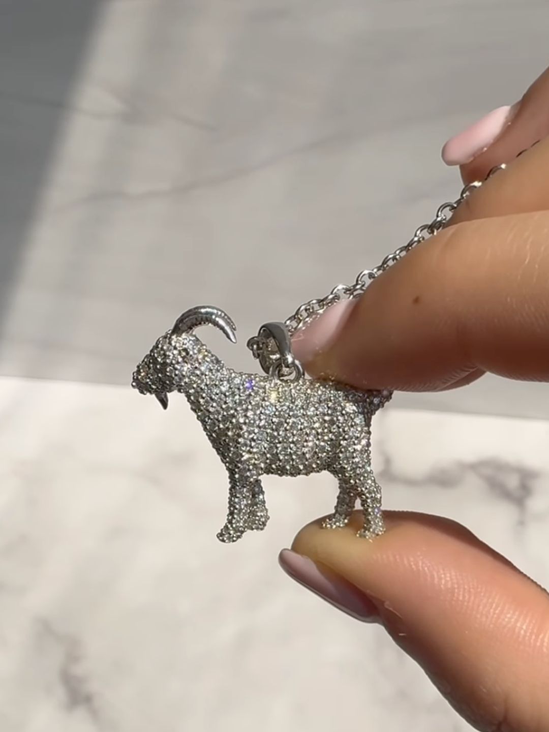 The pendant is a three-dimensional replica of a goat