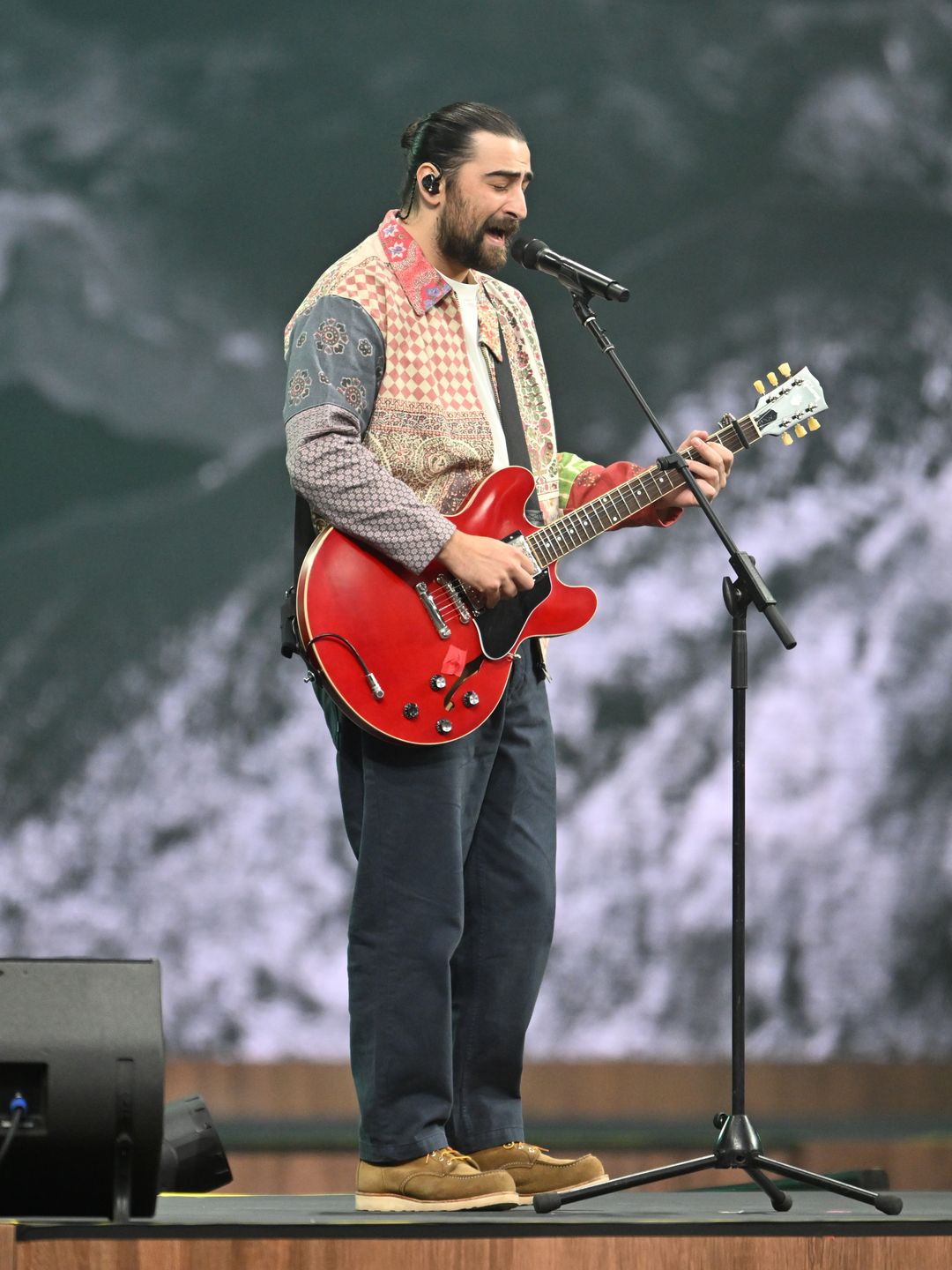 Noah Kahan performing on a guitar