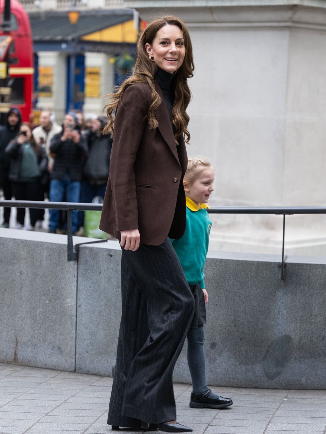 woman wearing trouser suit and brown blazer