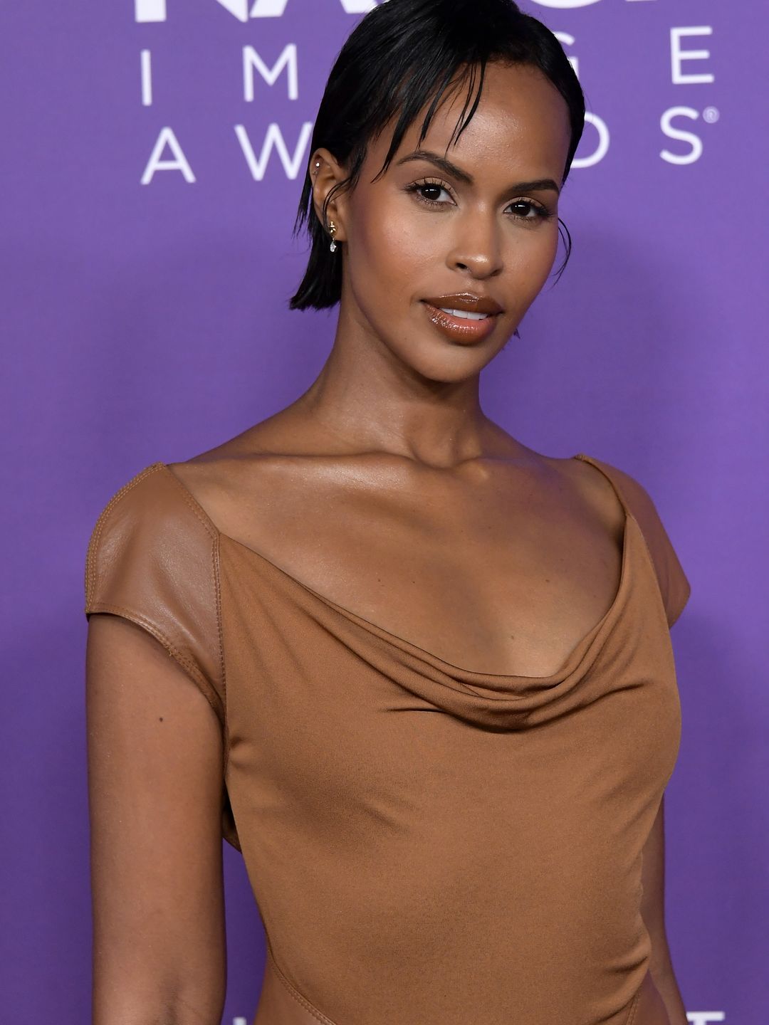 Sabrina Elba wears a wet look Bixie to the NAACP awards with a brown cowl neck dress 