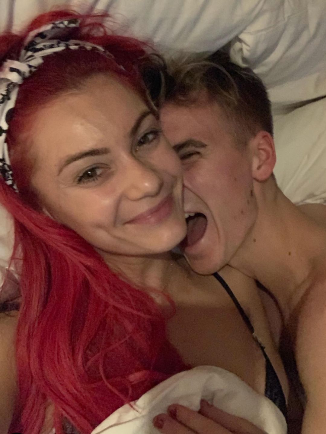 Dianne Buswell and Joe Sugg cuddling in a bed