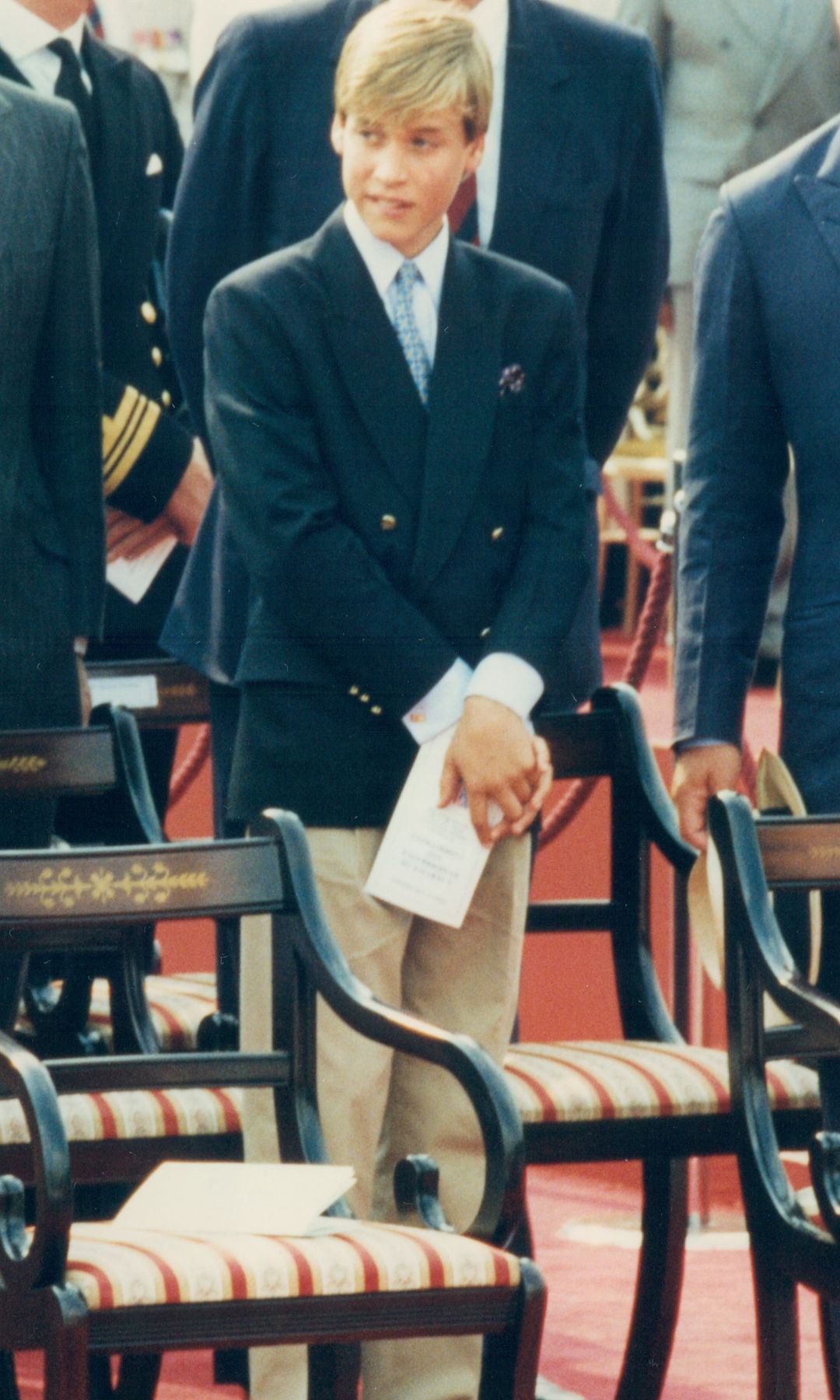 Prince William biting his lip in a blue jacket in 1995