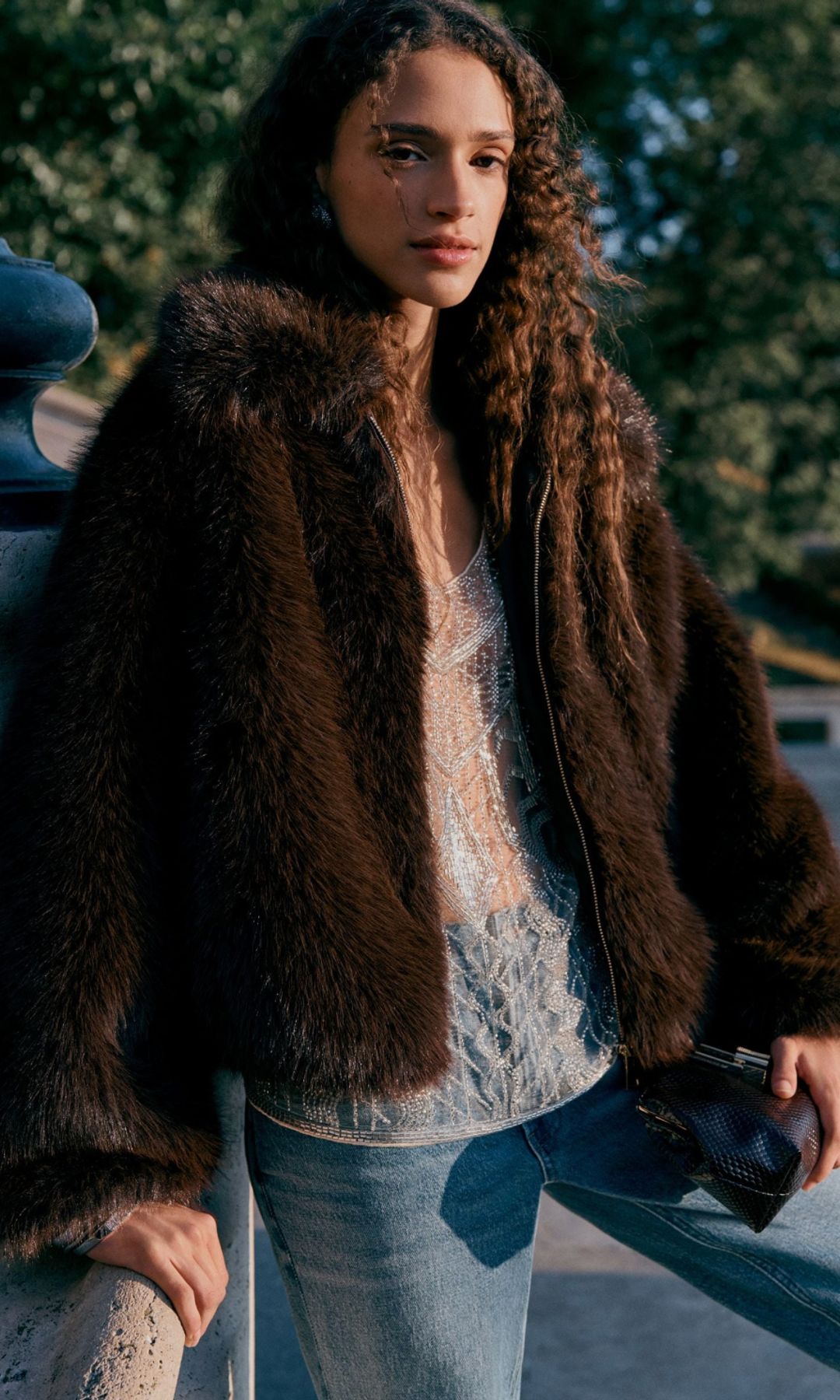 model wearing brown zip up fur coat