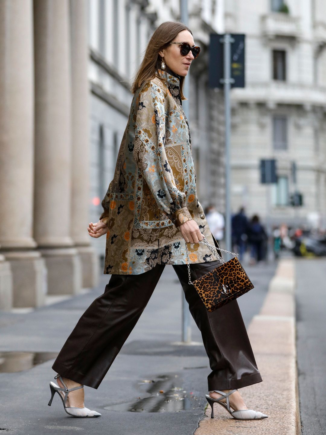 Annette Weber wears brown leather trousers and a floral tunic 