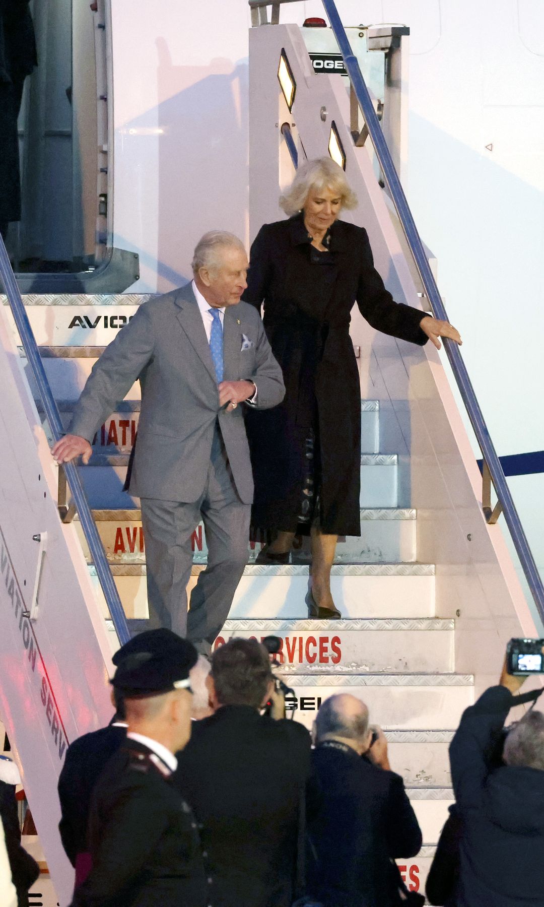 King Charles and Queen Camilla disembarking a plane