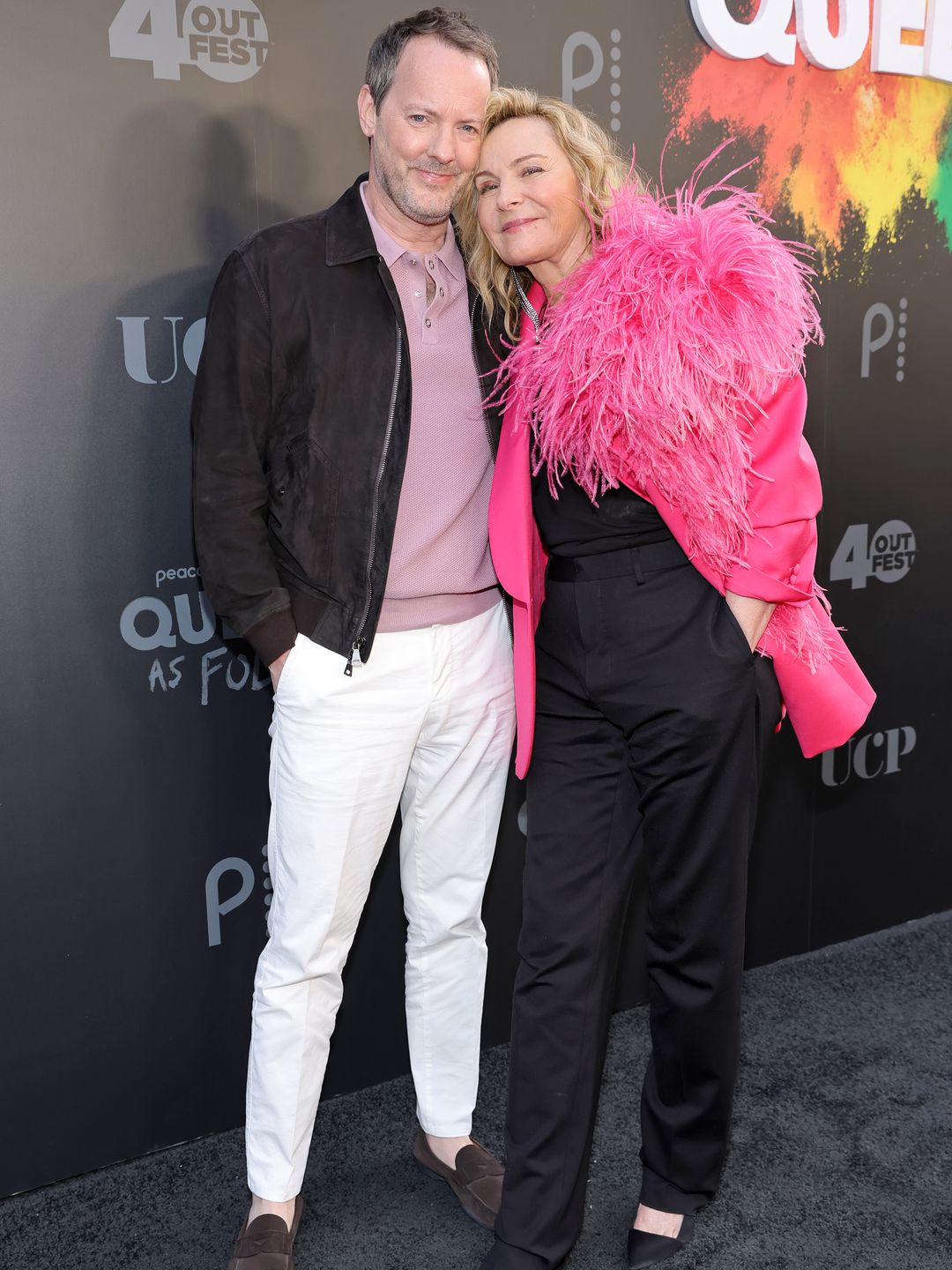 The couple smiling while attending the premiere of Peacock's Queer As Folk in 2022