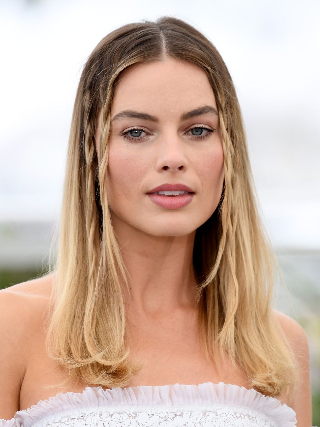 Margot Robbie with baby braids and understated makeup