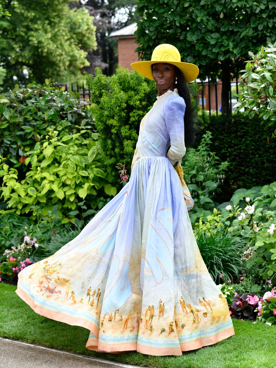 Model Eunice Olumide donned a Zimmermann dress which she paired with a striking yellow hat. 