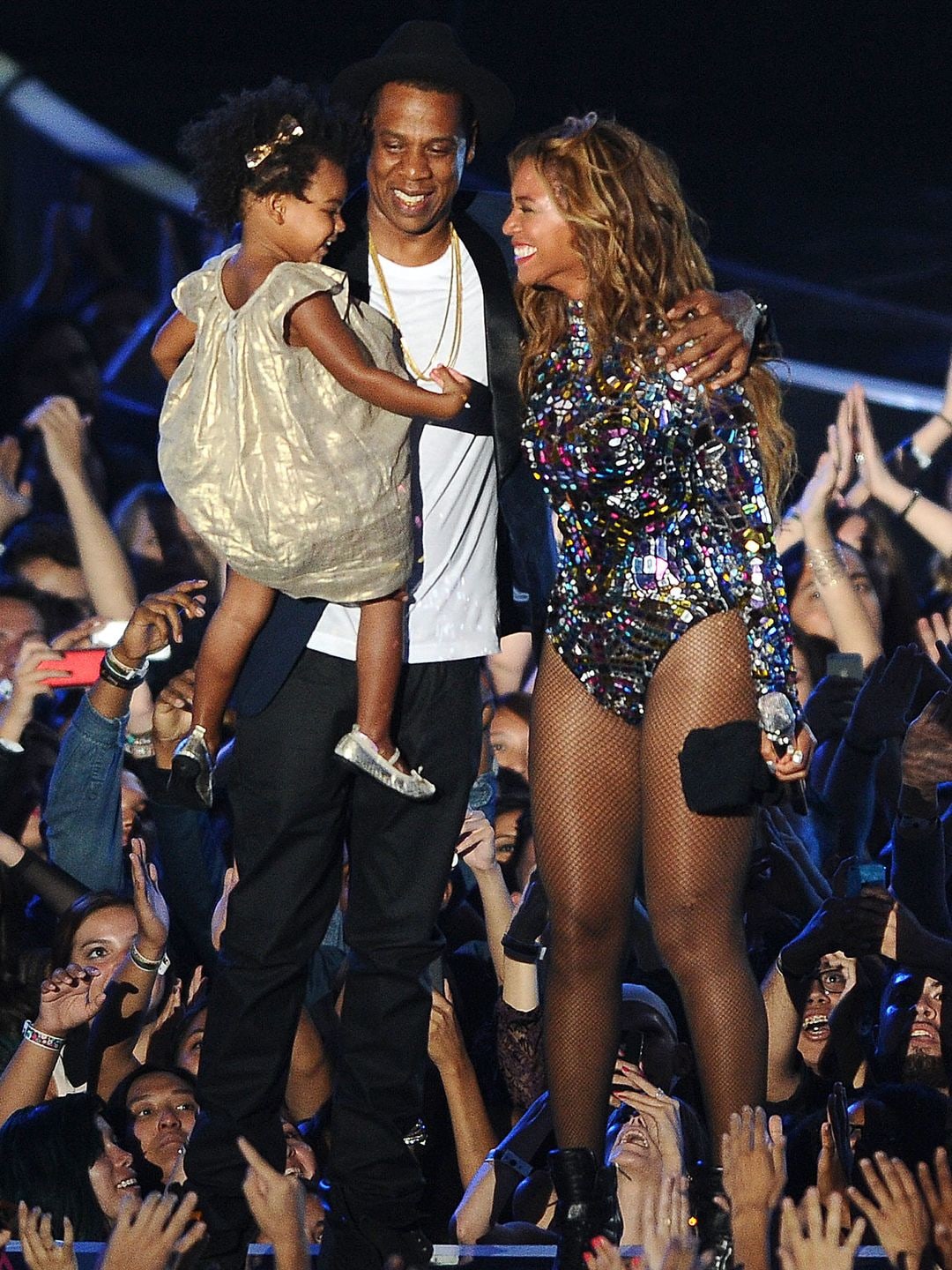 Beyonce and Jay Z stood beaming on a stage, Jay-Z has Blue Ivy sat in his arms