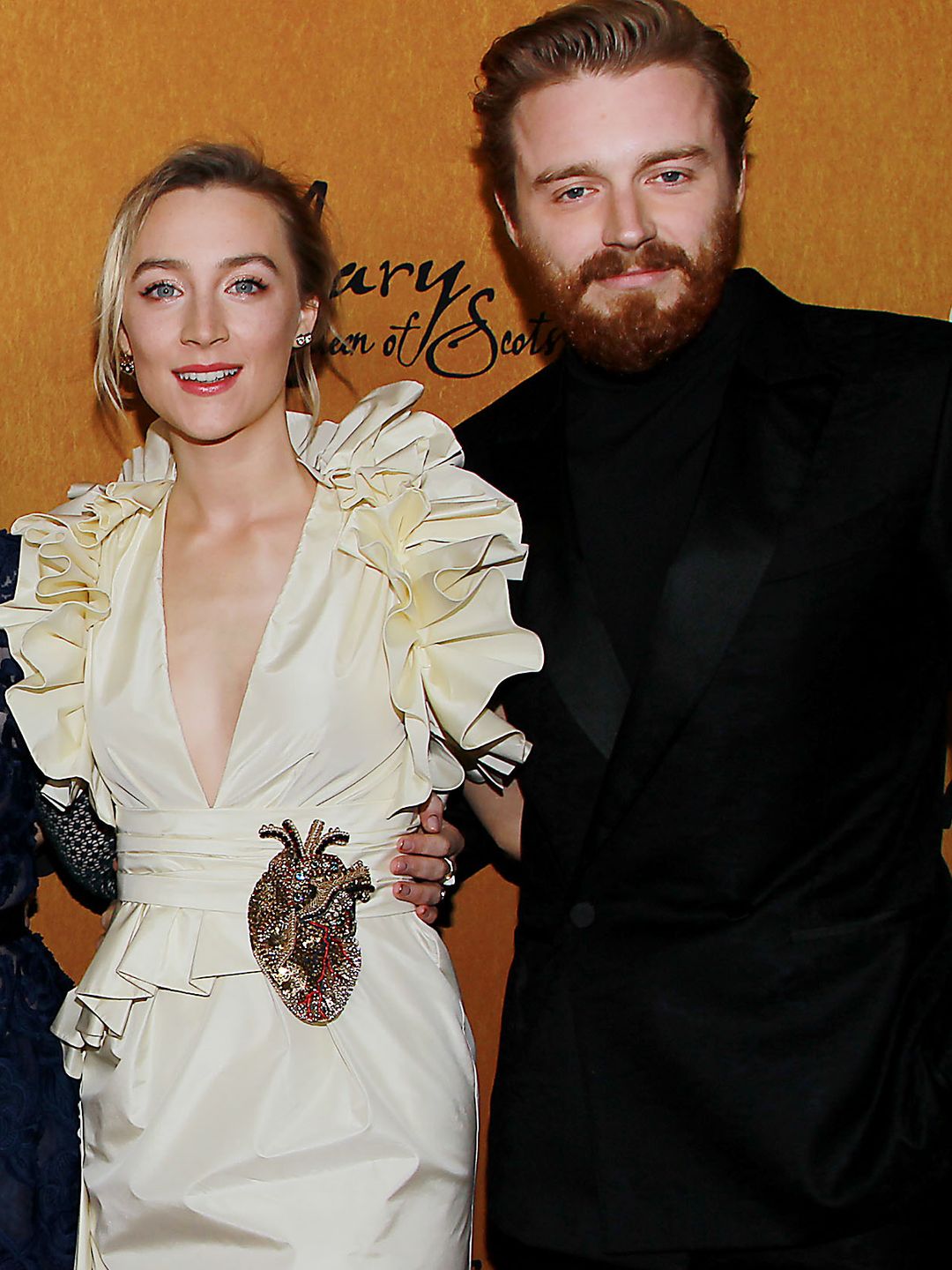 Saoirse Ronan in a yellow ruffled dress with Jack Lowden