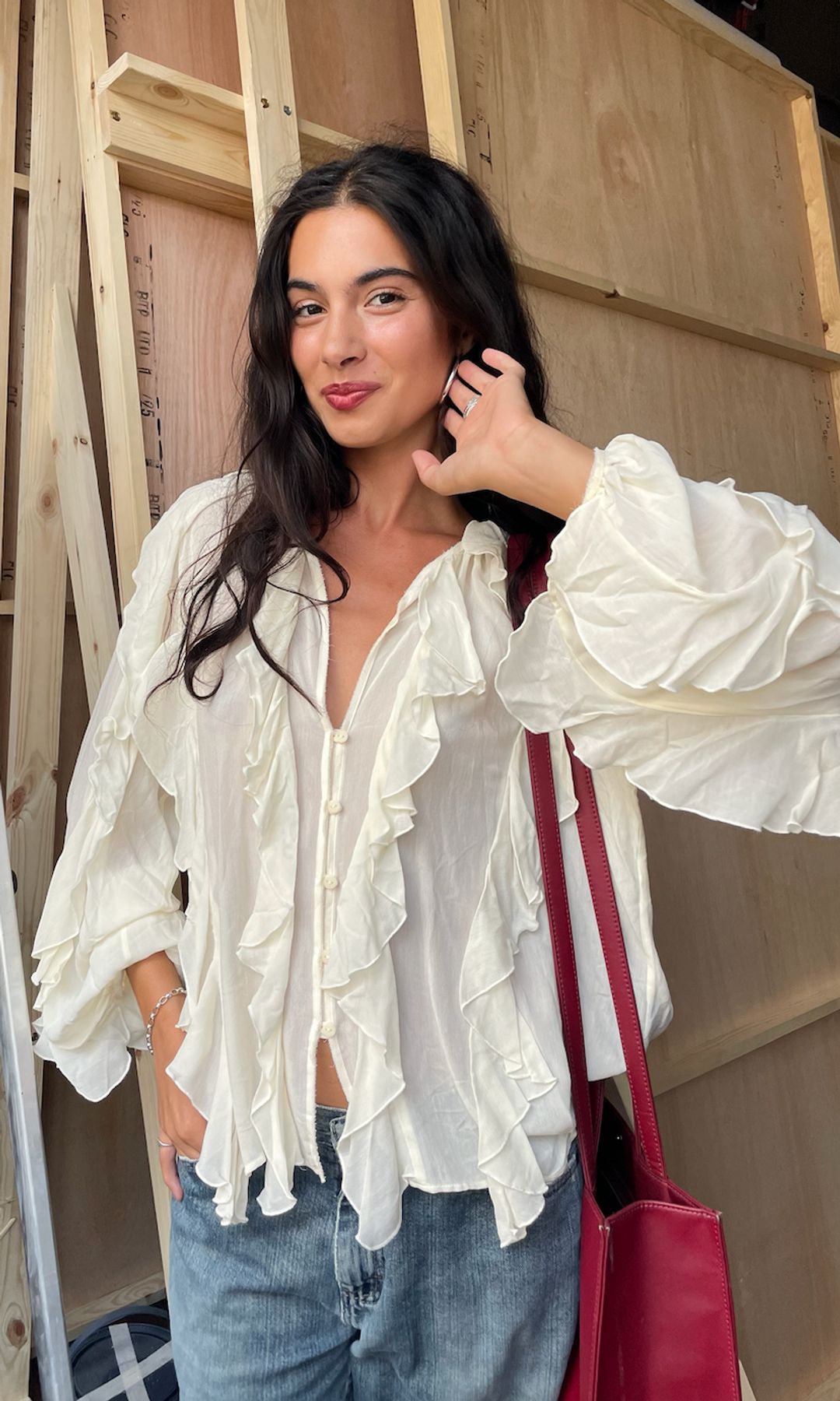 sofia wimberly in white blouse and jeans