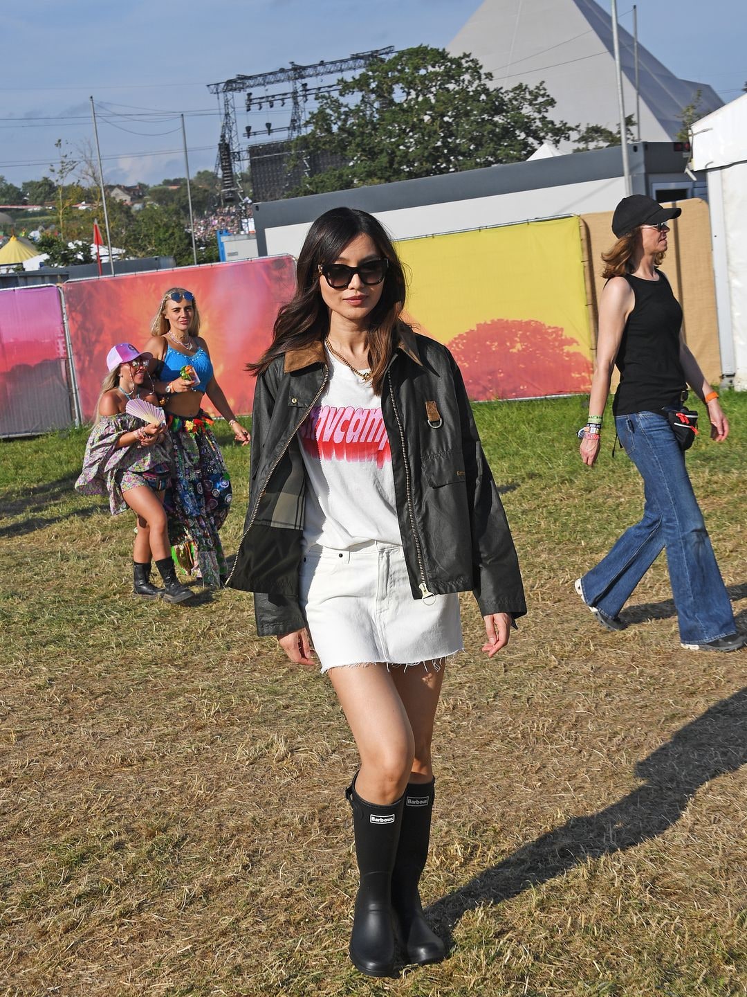 GLASTONBURY, ENGLAND - JUNE 23: Gemma Chan is seen on day one of the Glastonbury Festival wearing her Barbour wax jacket on June 23, 2023 in Glastonbury, England. (Photo by Dave Benett/Getty Images)