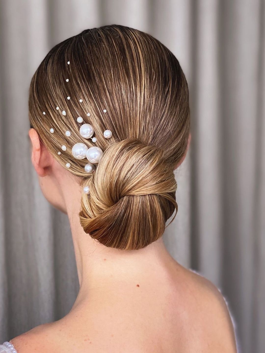 Hair in a bun with pearl accents 