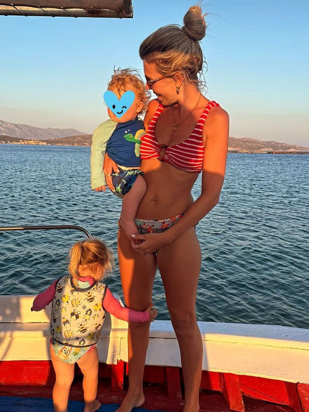 Carrie Johnson in a bikini with two kids on a boat