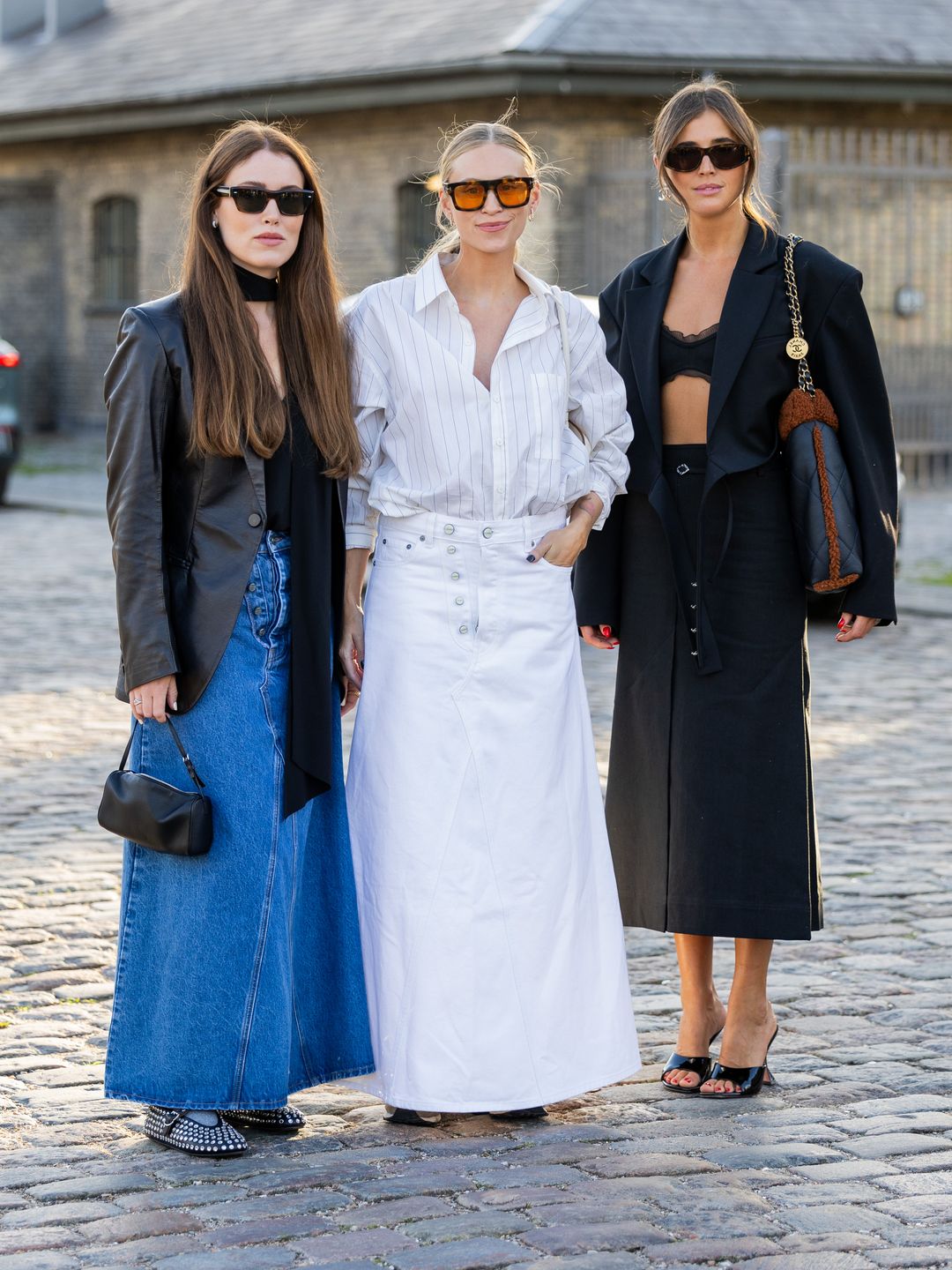 Annabel Rosendahl, Tine Andrea and Darja Barannik wearing the transitional staple: the maxi skirt outside the Ganni show in Copenhagen. 