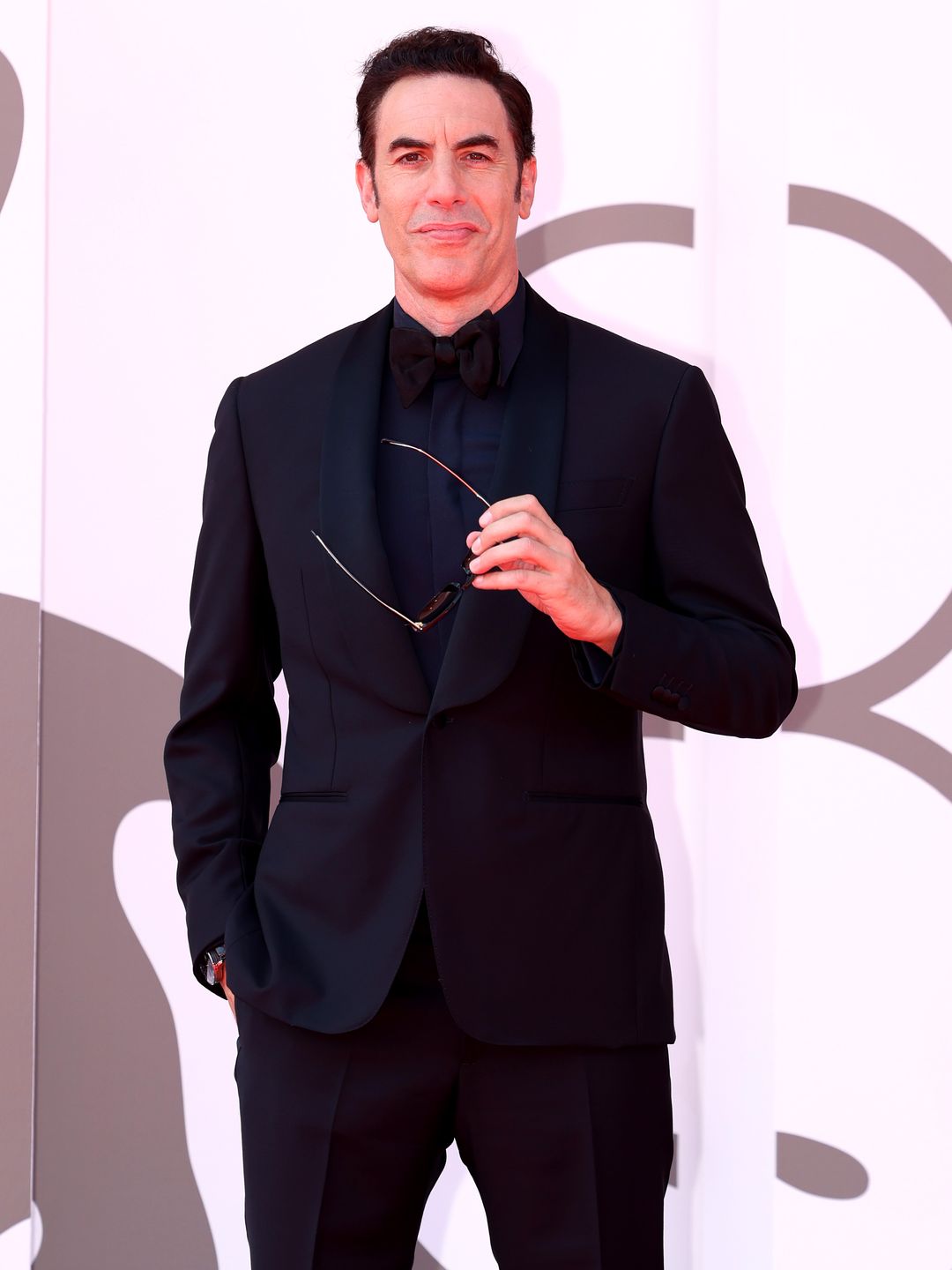 Sacha Baron Cohen in a black suit