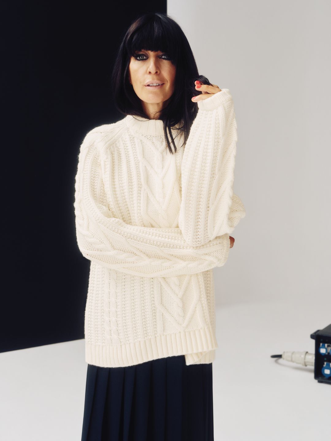 Claudia Winkleman backstage on set for Jaeger collection wearing cream jumper and black skirt