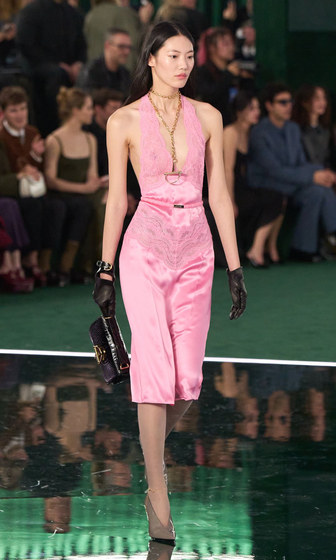 A photo of a model walking for Gucci FW25 in a pink slip dress