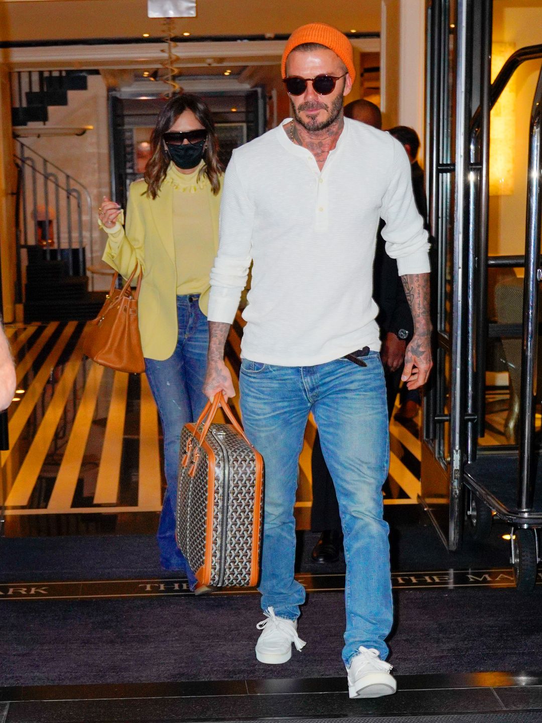 David and Victoria Beckham walking out a hotel 
