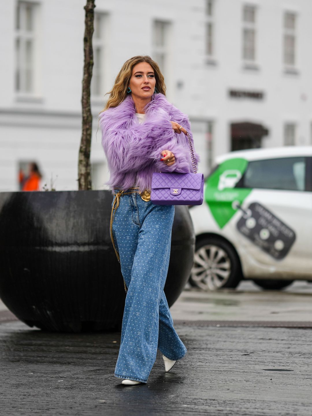 Emili Sindlev wearing a fluffy purple jacket 