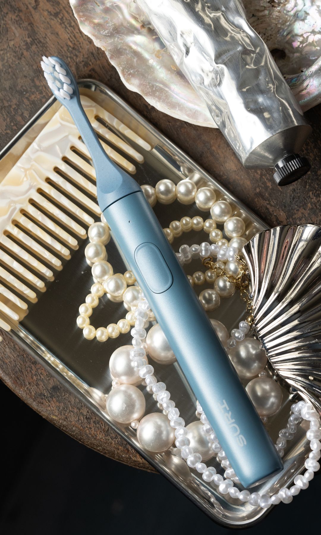 Suri blue toothbrush on a silver tray