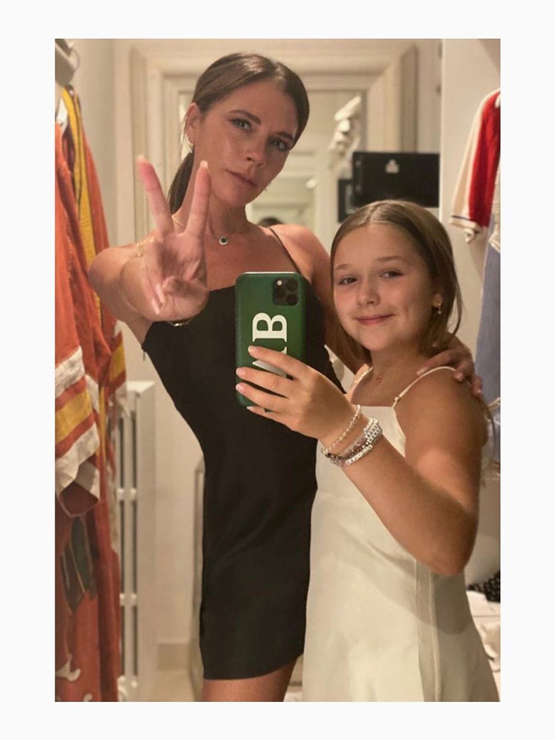 mother and daughter taking mirror selfie