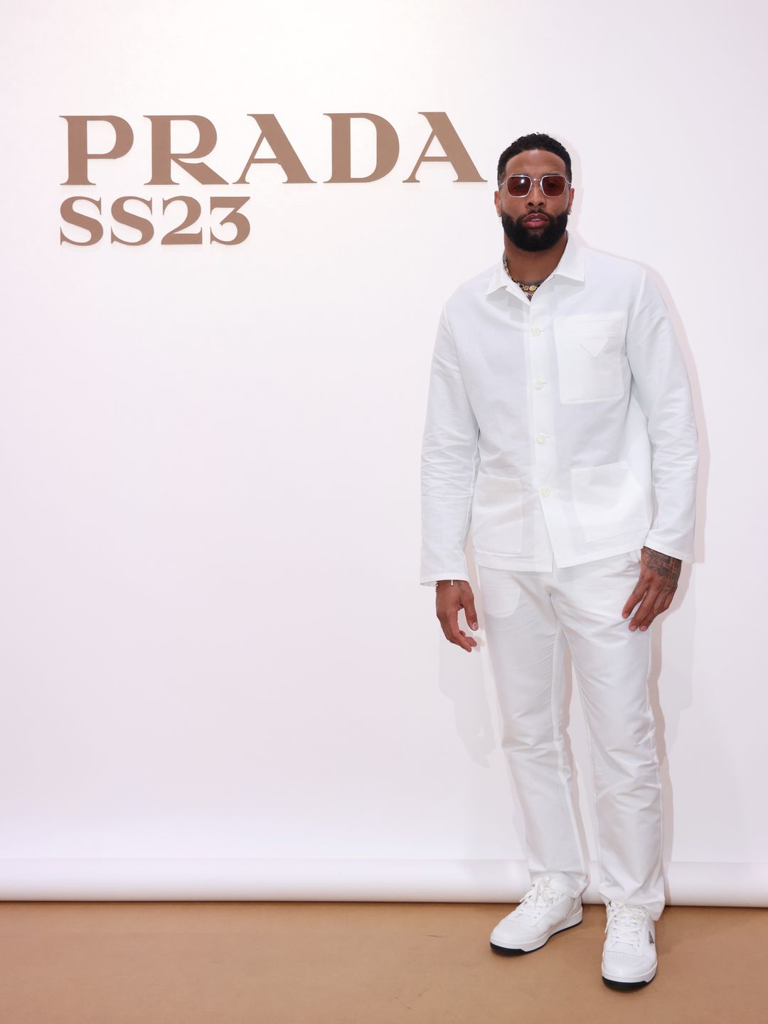Odell Beckham Jr attends Prada Spring/Summer 2023 Menswear Fashion Show in an all white suit 